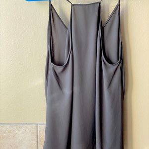 Olive green flows tank top. Hit at hips. Front is a little shorter than back